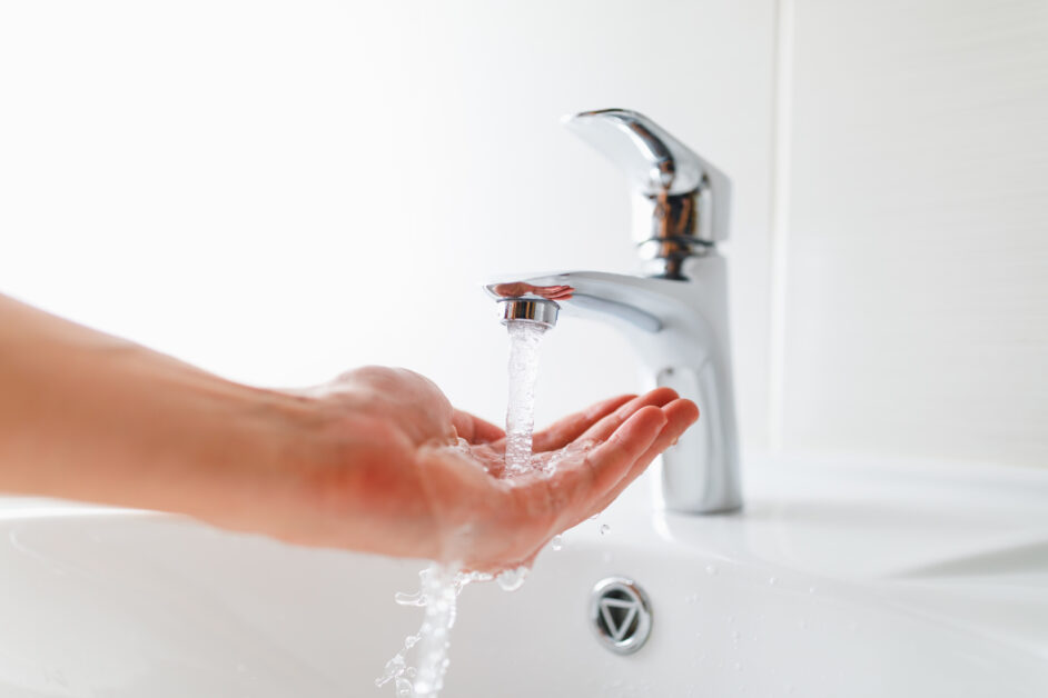 hand under faucet with water stream