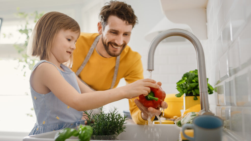 father and daughter cooking together