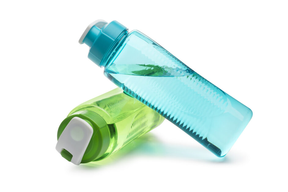 blue water bottle leaning on green water bottle