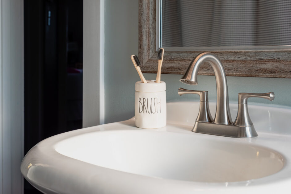 toothbrushes in a ceramic holder