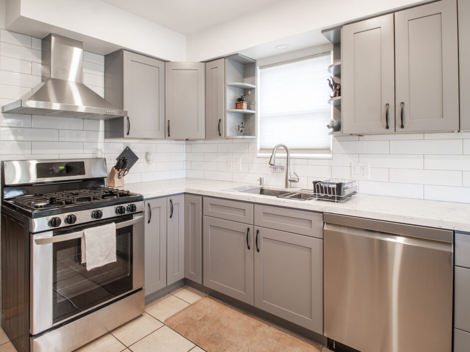 kitchen with grey cabinets and stainless steel appliances