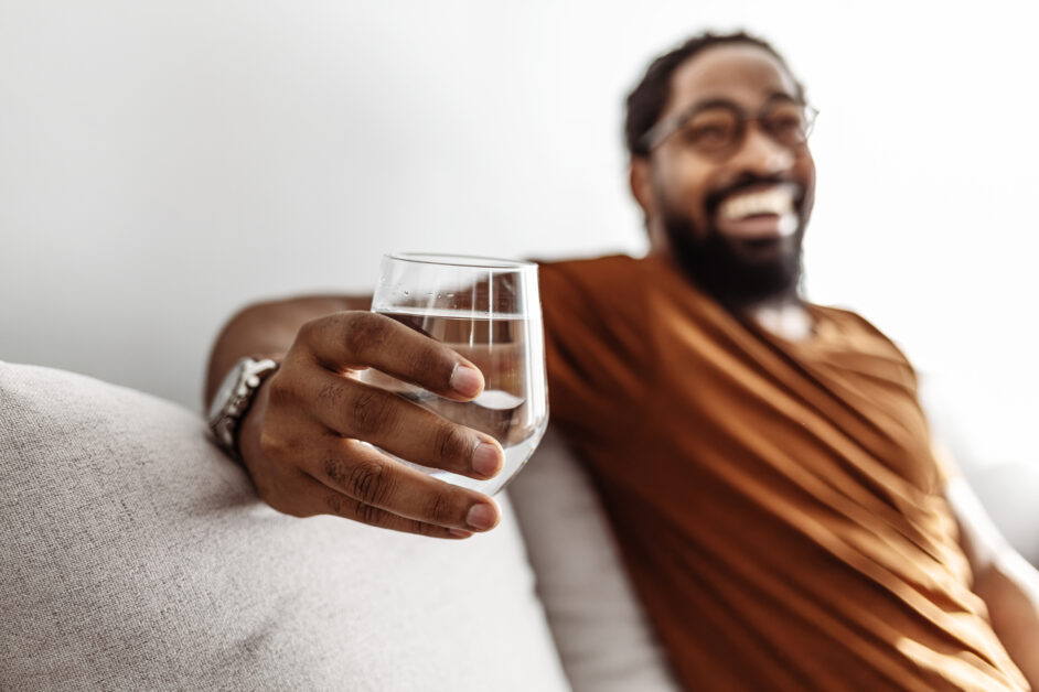 man drinking a glass of water