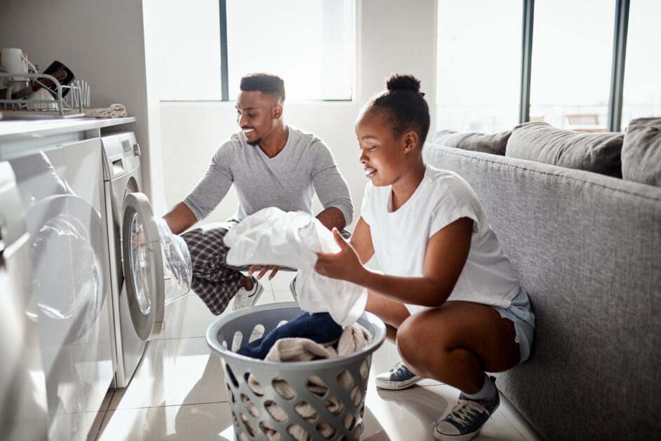 couple doing laundry together at home