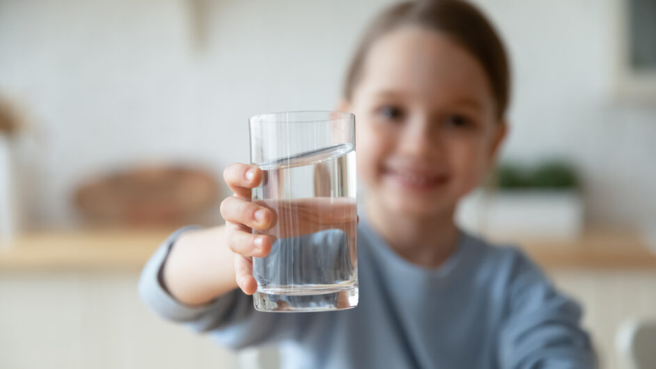 girl holding water glass