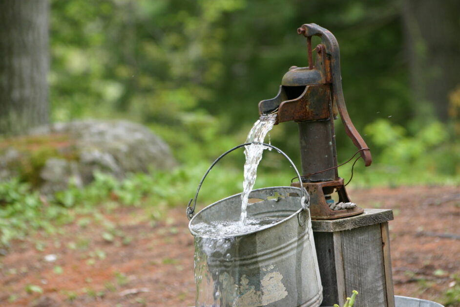 water pump spilling water into bucket