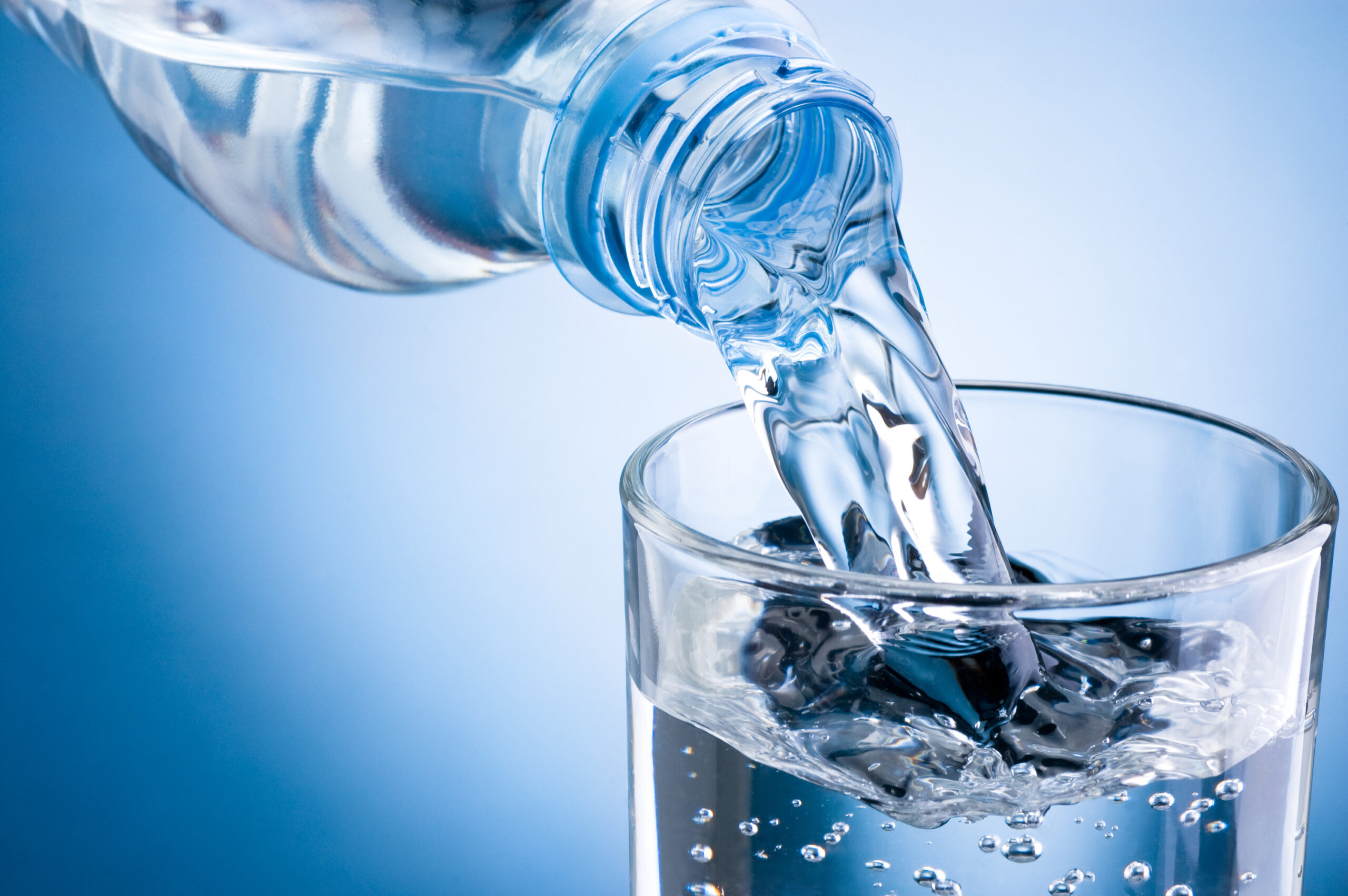 pouring water from bottle into glass