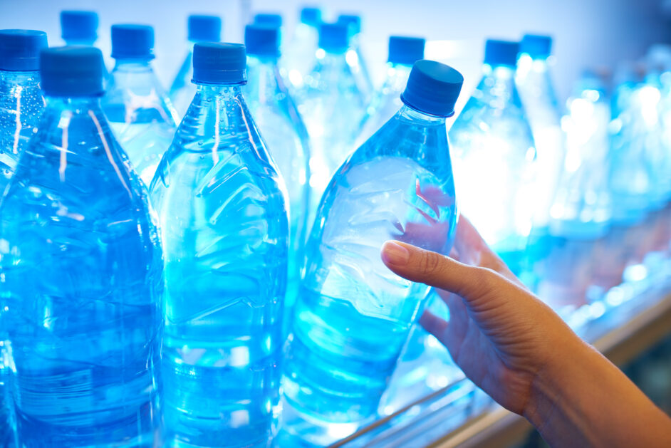 hand taking water from shelf in supermarket