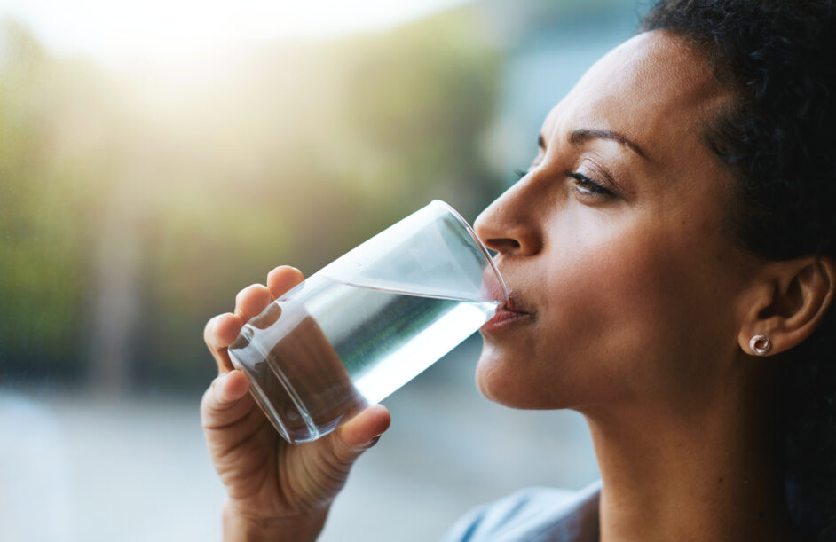 woman drinking a glass of water