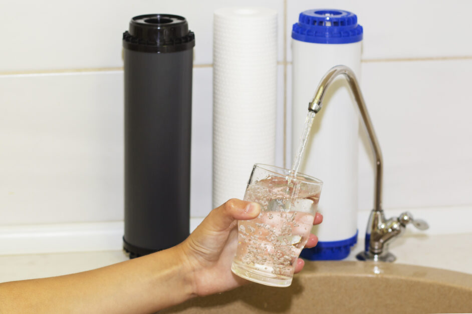 hand filling glass with water