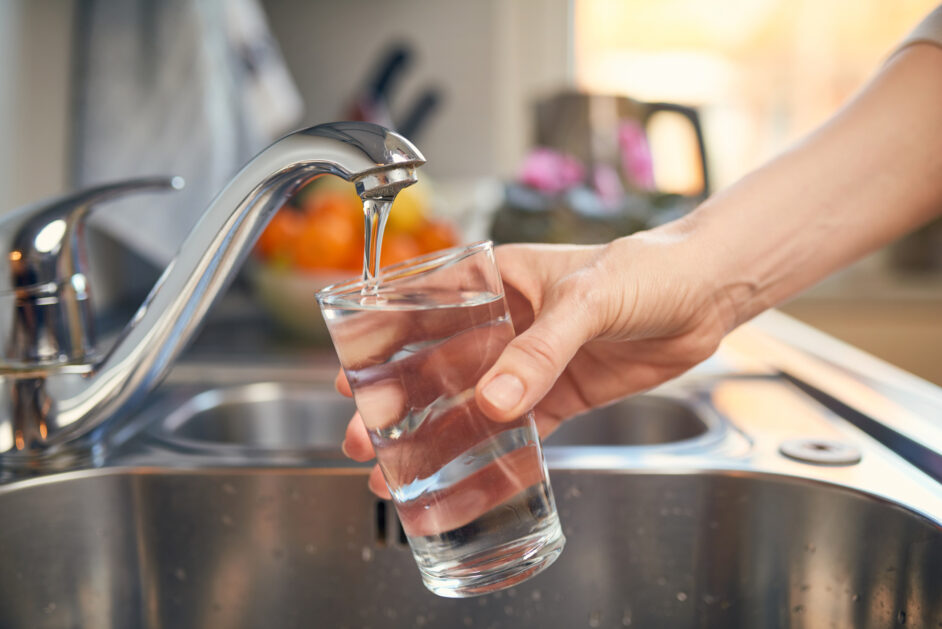 pouring fresh tap water into a glass