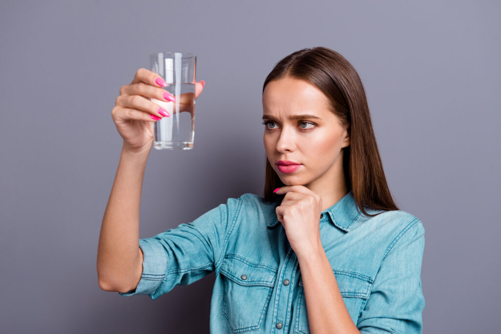 woman holding a glass of water