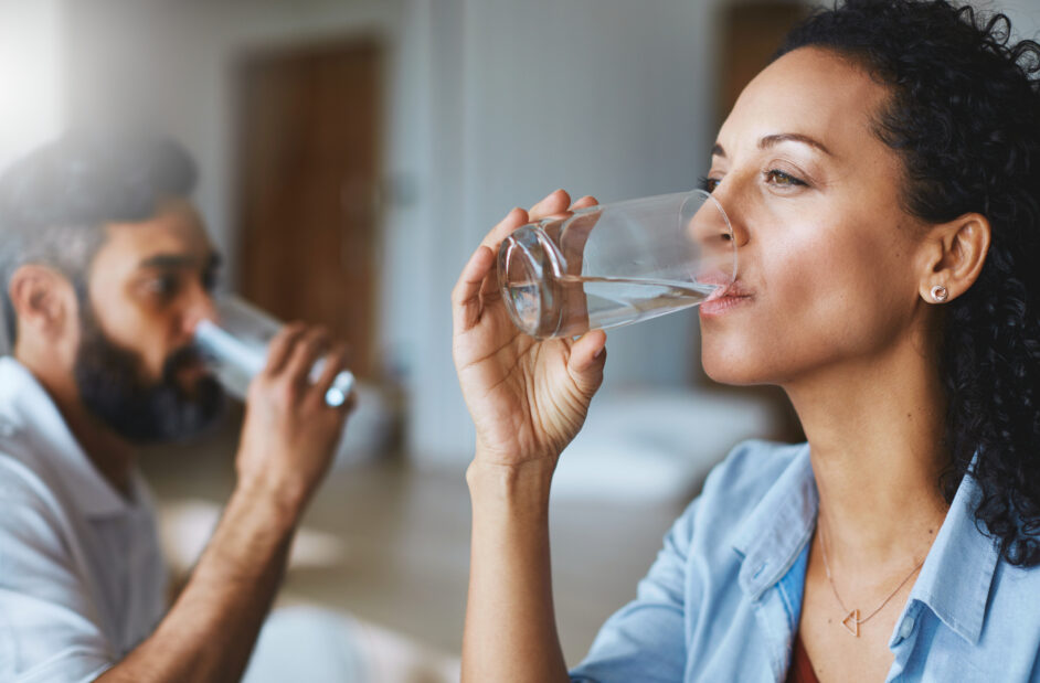 couple drinking glasses of water together